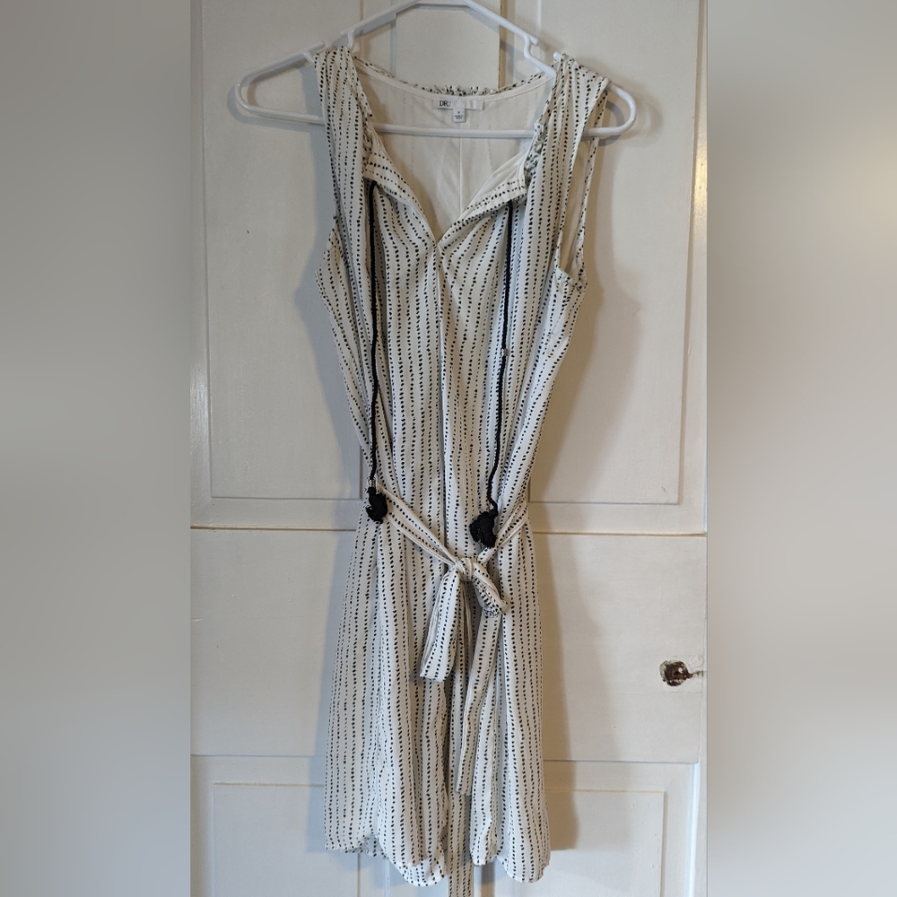 Small, sleeveless printed dress with tassel and waist tie.